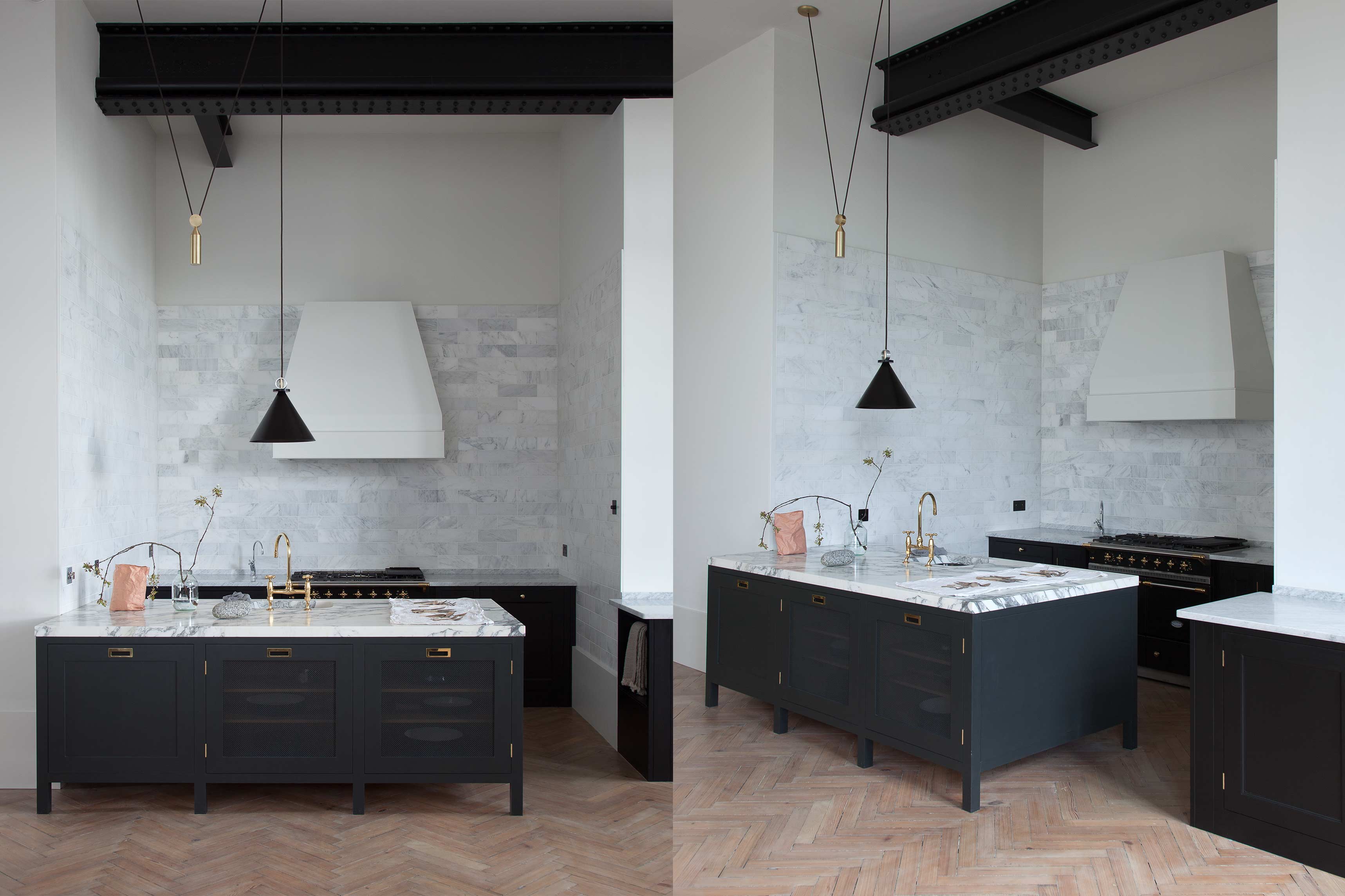  Dual view of a modern kitchen with black cabinetry, marble countertops, gold fixtures, and white hood under industrial lighting.