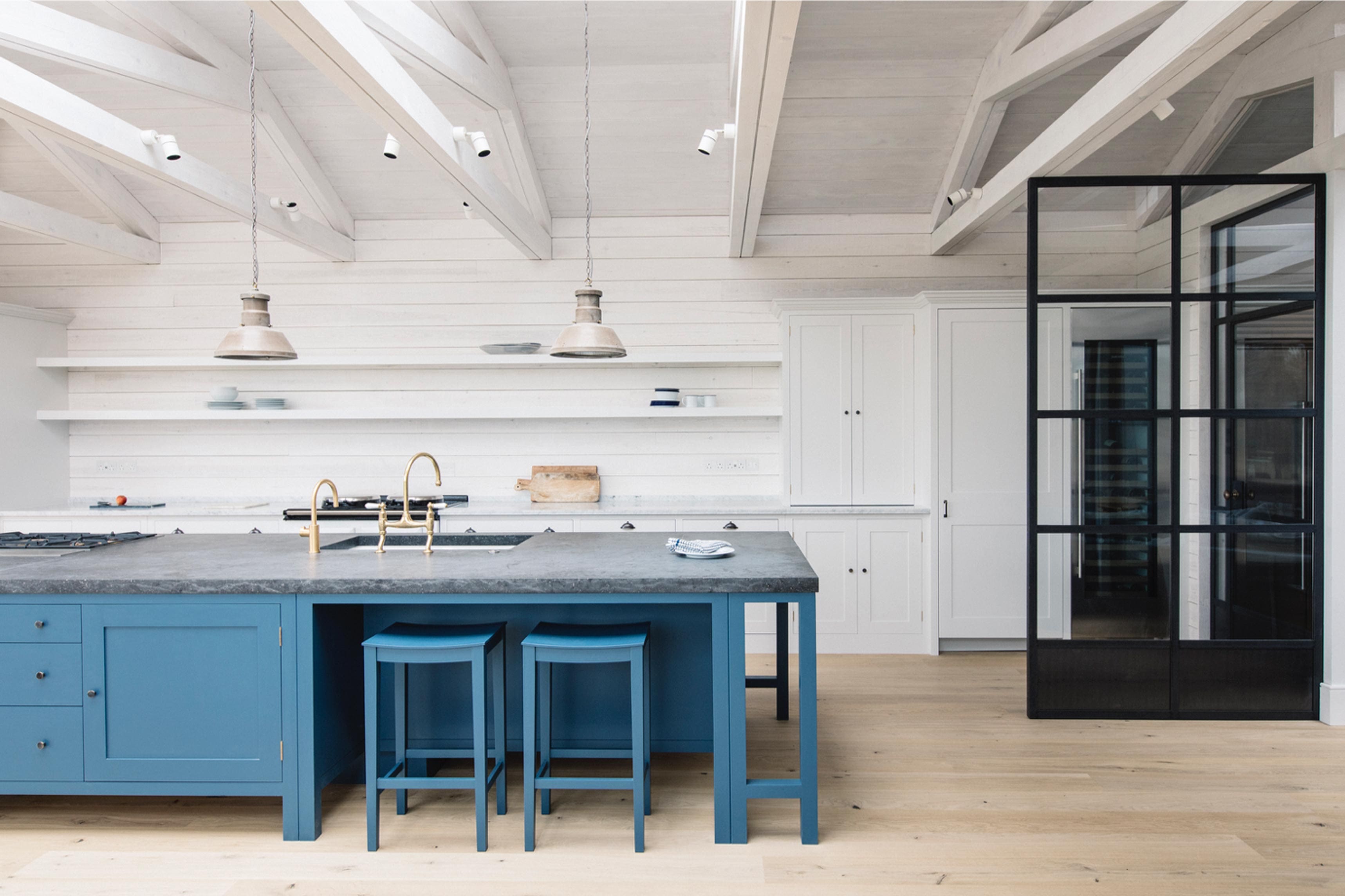  Large kitchen space featuring Belgian Blue Fossil Stone worktop and whitewashed walls