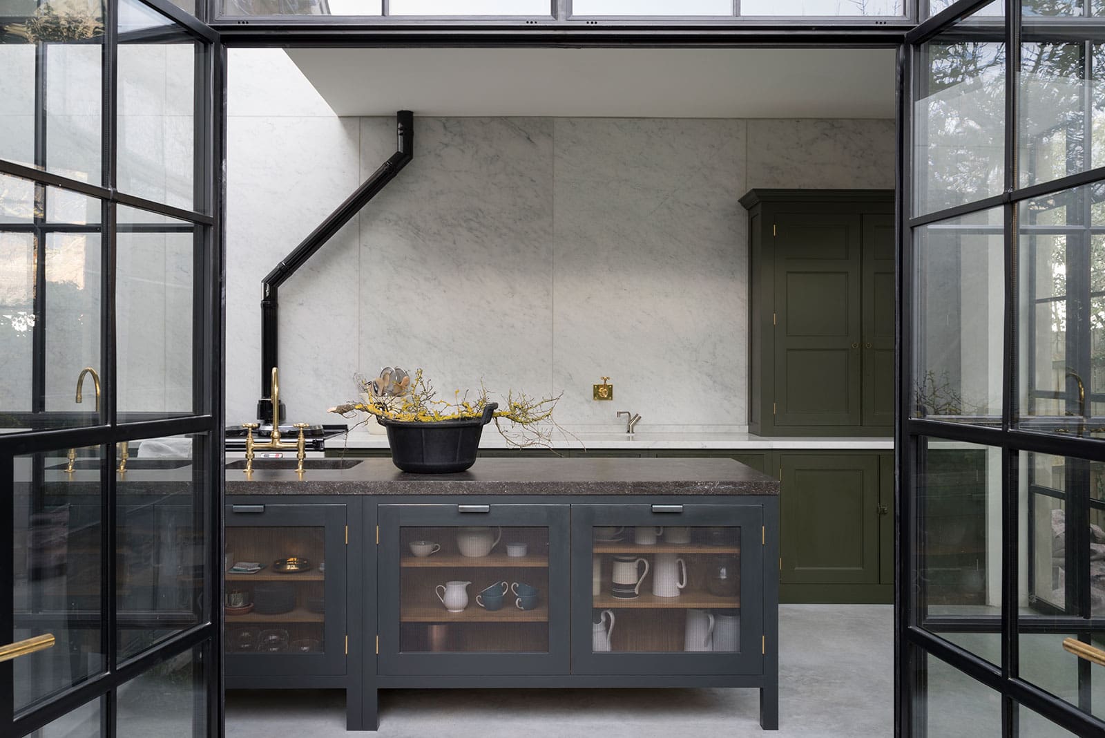  Urban kitchen with Army Camp-painted Spitalfields cupboards, Fournier doors, Carrara marble walls, and fossil stone worktops.