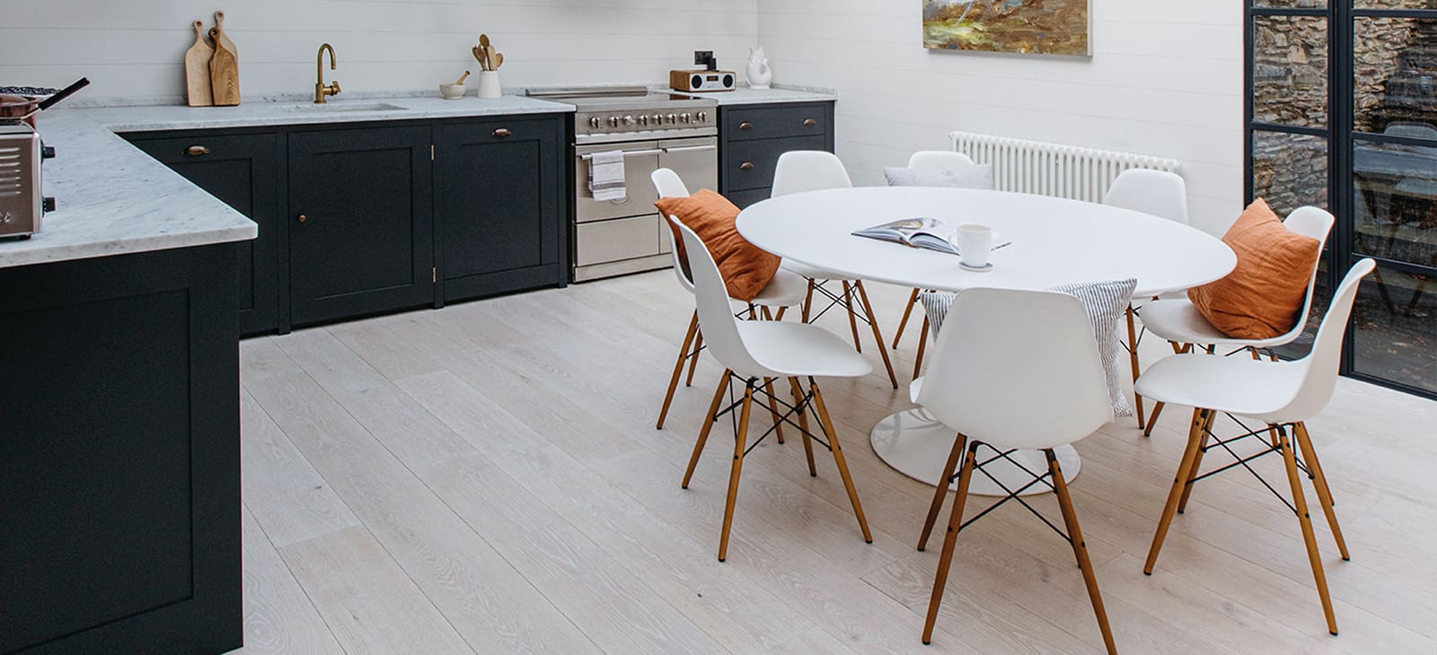  Nearly black kitchen cabinetry with a marble countertop in Cornish Cliff House.