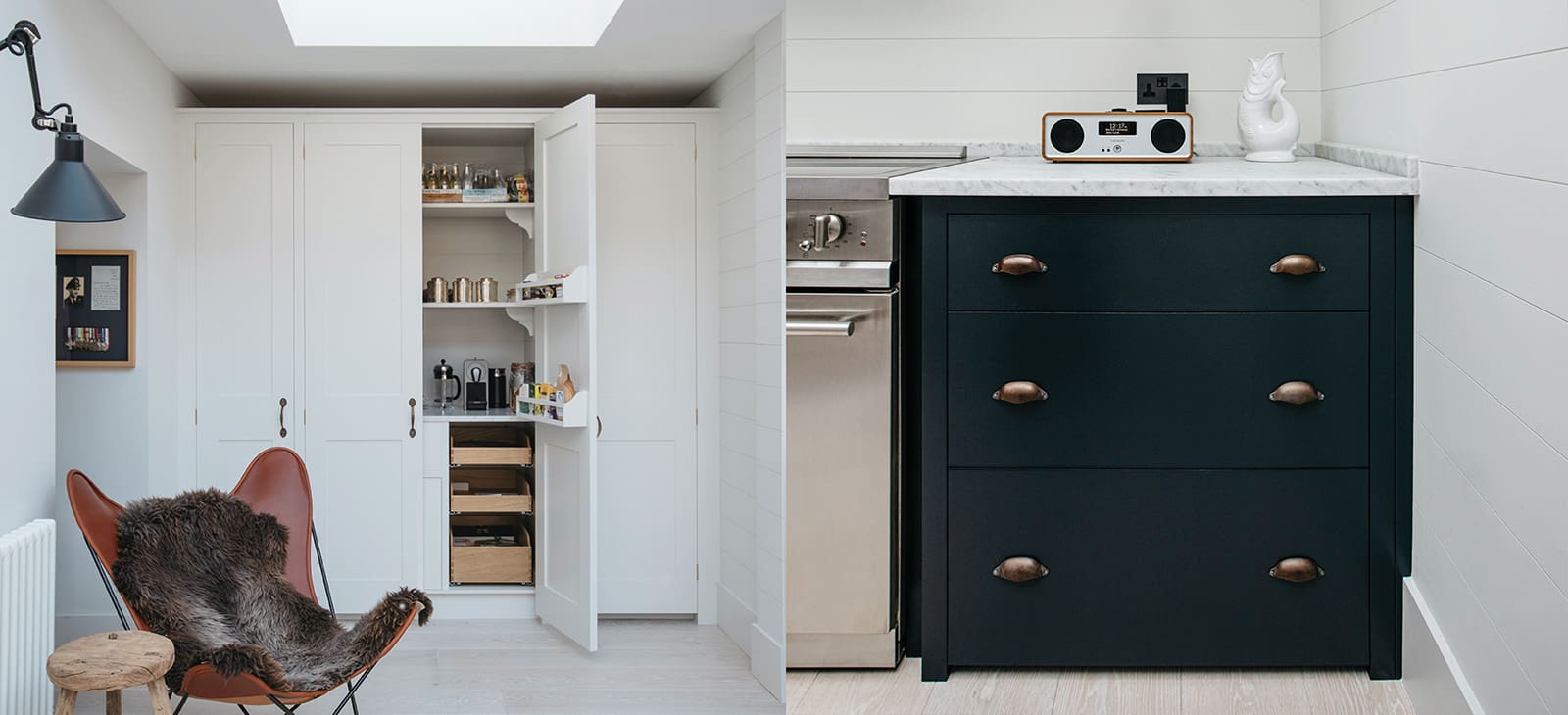  White tall cupboards and nearly black kitchen cabintry with marble countertop.
