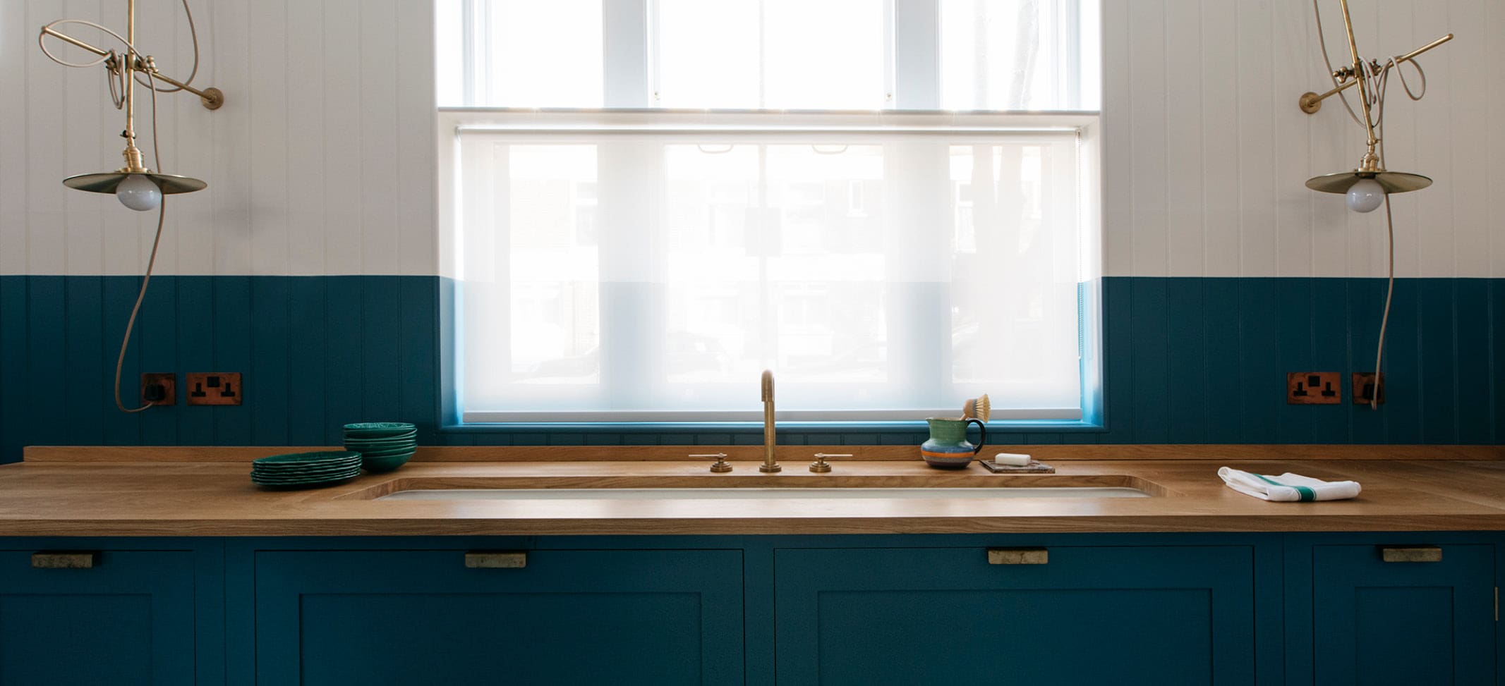  Mid-blue paint cabinets and natural wood countertops at Notting Hill Atelier Studio Kitchen