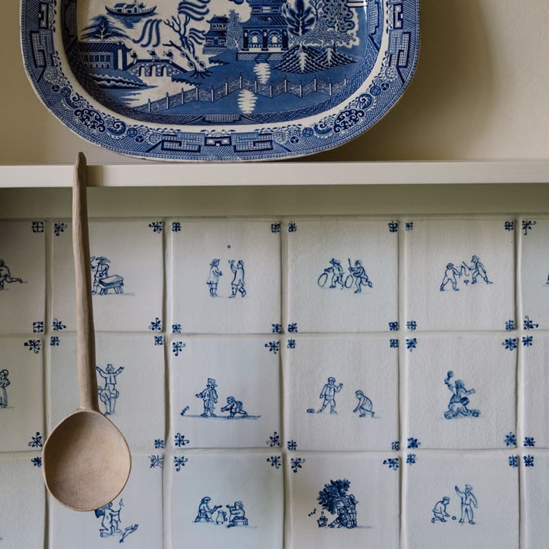 Close up of a custom delft tile backsplash.