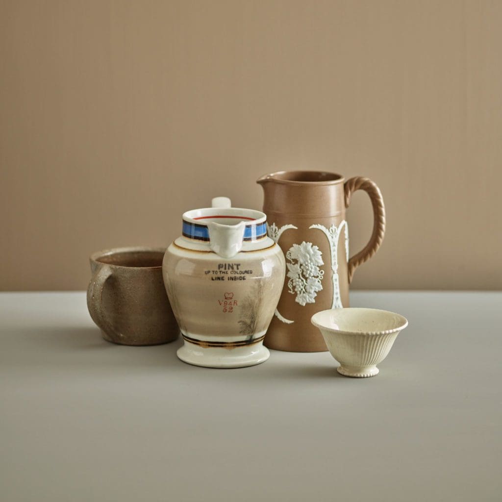 Close up of neautral coloured pitchers and cups.