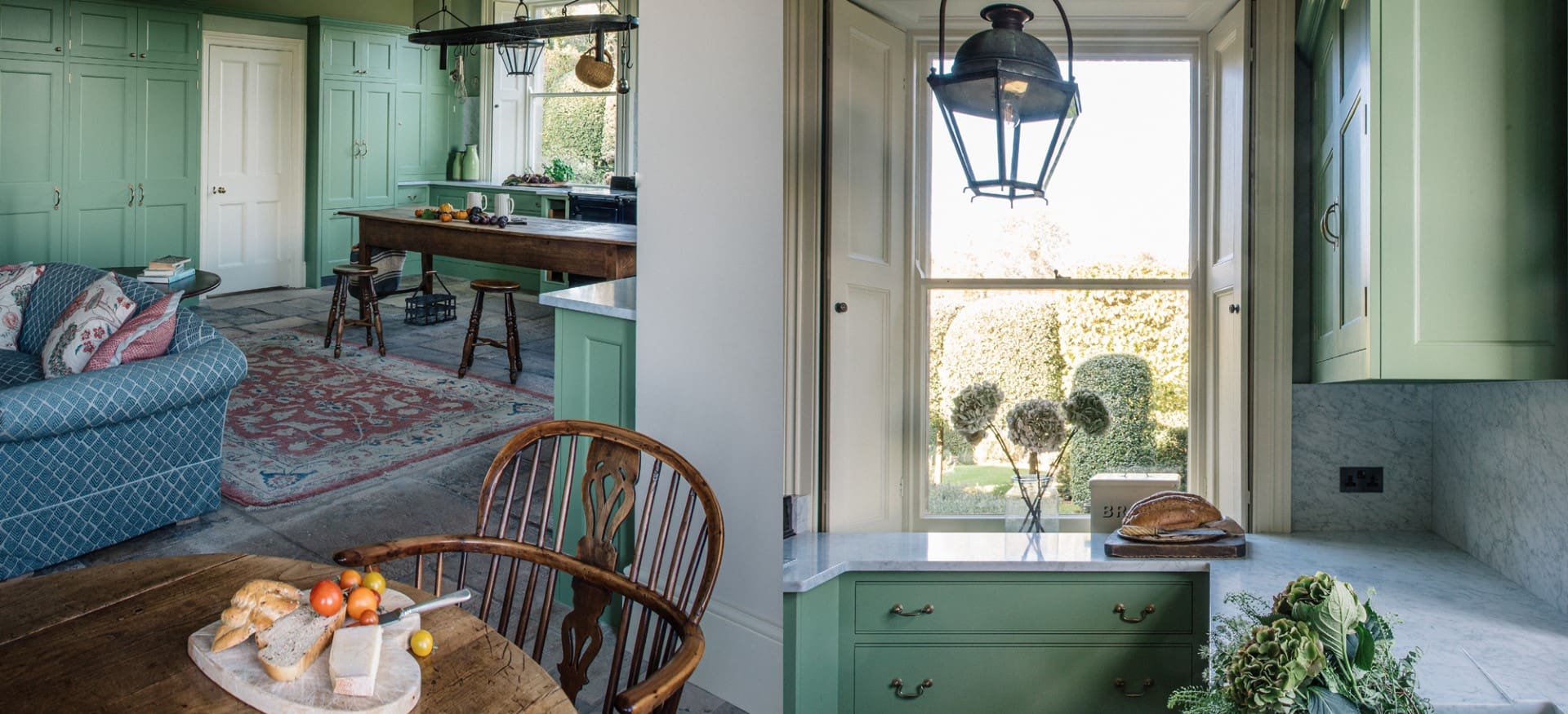  Traditional kitchen with green-painted cabinets, marble countertops, rustic wood table, and cozy sitting area.