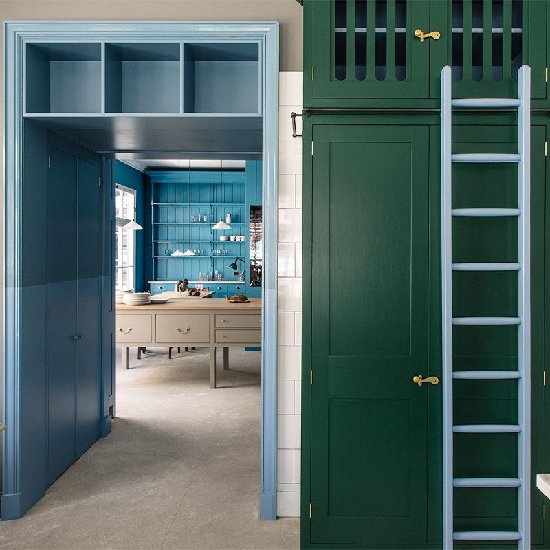 Close up of the Plain English Los Angeles showroom, featuring custom green and blue cabinets.