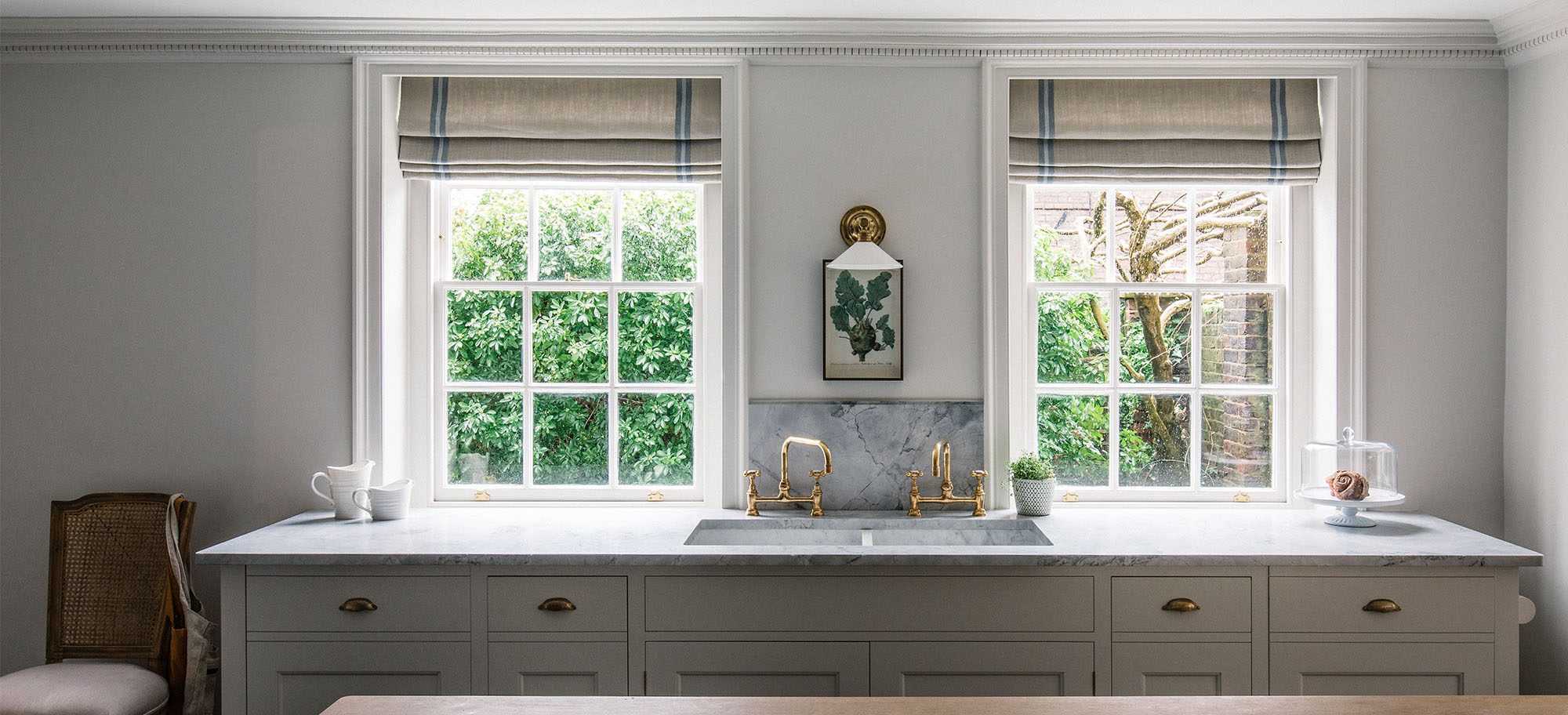  Elegant kitchen featuring a double marble sink, brass taps, and a Pippy Oak worktable.