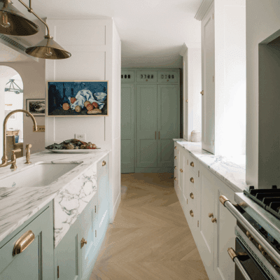 Bespoke kitchen design by Plain English, featuring soft grey cabinetry, a white marble countertop, and minimalist hardware.