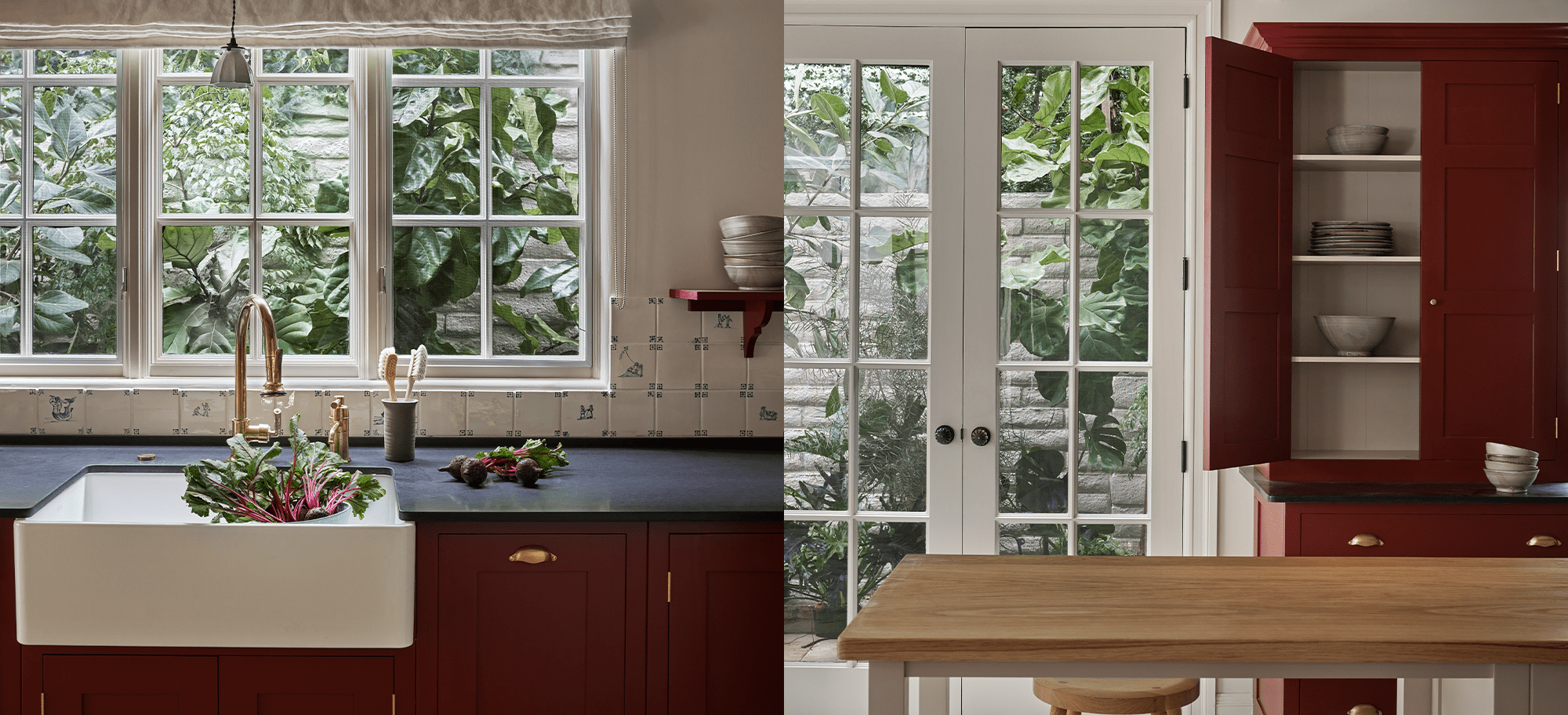  Red kitchen sink area with brass facet, blue countertip, red cabintry with open doors, light wood table, and glass-paneled doors.