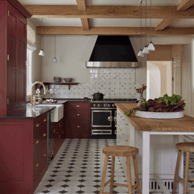 Square thumbnail image of a custom kitchen design by Plain English, featuring neutral-toned cabinetry, a white countertop, and contemporary open shelving.