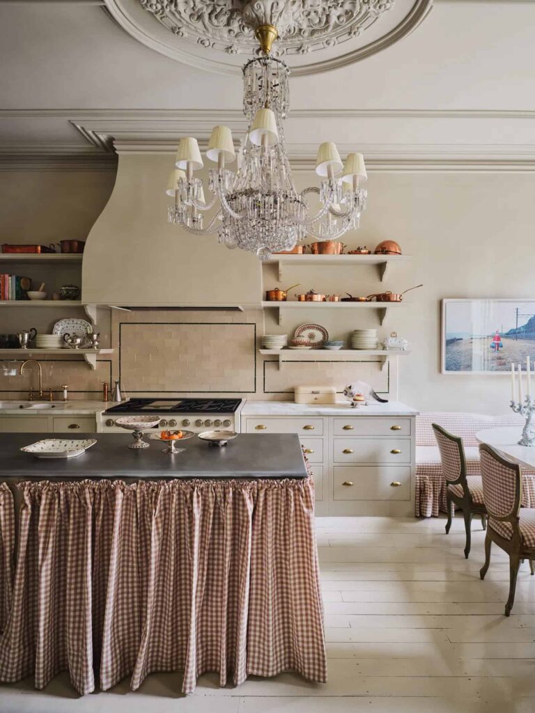 David Harbour and Lily Allen's English-styled kitchen in their Brooklyn townhouse with a large central island skirted with a gingham curtain