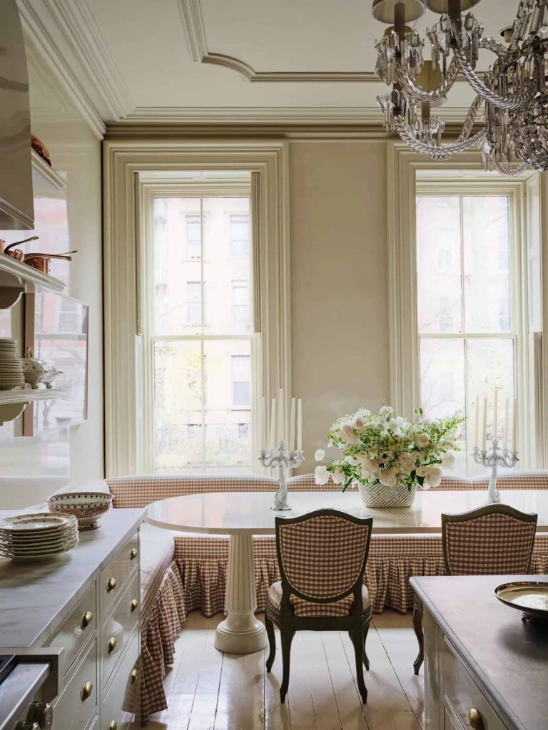 David Harbour and Lily Allen's Brooklyn brownstone kitchen featuring a neutral color palette, with plum-colored checkered fabric and chairs
