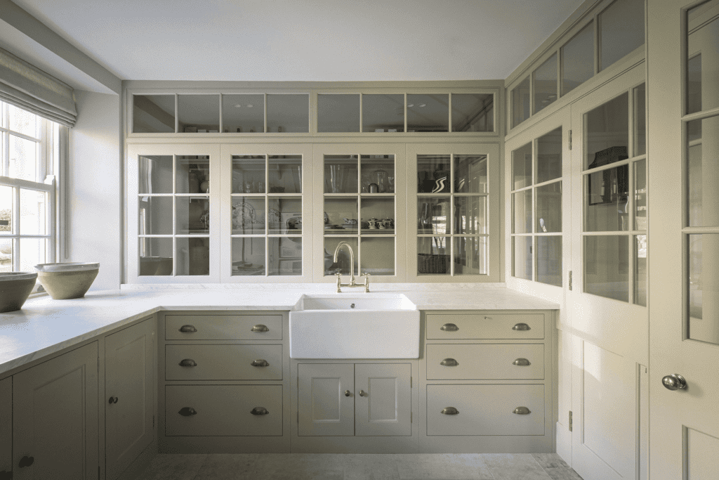 a classic English style kitchen with bespoke cabinetry and a built-in butlers pantry or scullery area