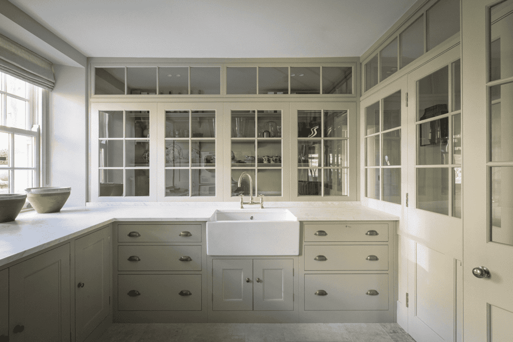 a classic style kitchen with custom cabinetry painted in a soft, light gray called 